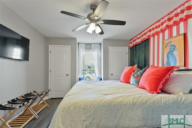 bedroom with ceiling fan and dark hardwood / wood-style flooring