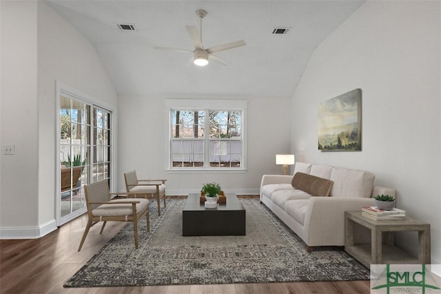 living room featuring ceiling fan, dark hardwood / wood-style floors, and vaulted ceiling