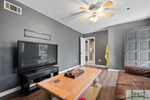 living room with ceiling fan, a textured ceiling, and wood-type flooring