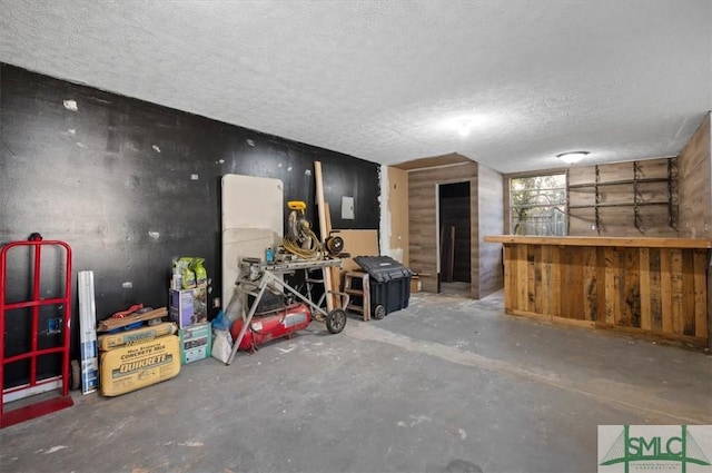 interior space with a textured ceiling and concrete flooring