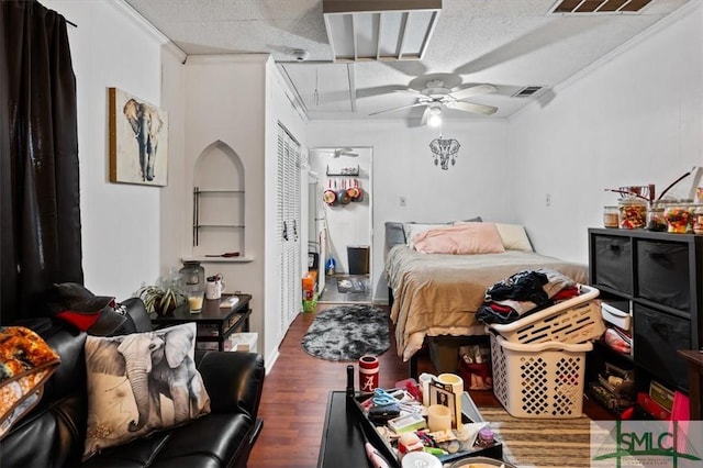 bedroom with ceiling fan, dark hardwood / wood-style flooring, crown molding, and a textured ceiling