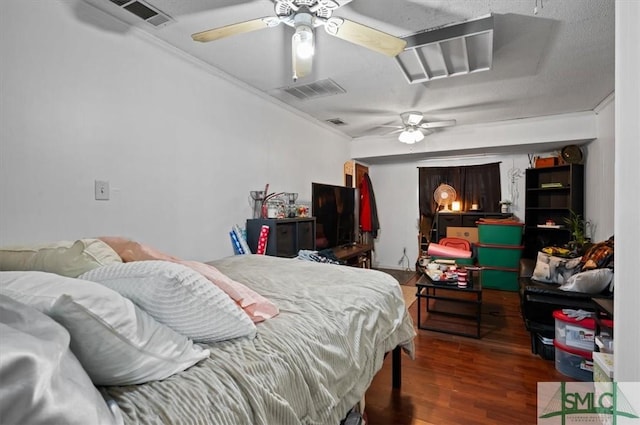 bedroom featuring ceiling fan, dark wood-type flooring, crown molding, and a textured ceiling