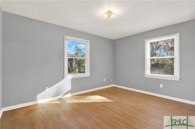 unfurnished room with hardwood / wood-style floors