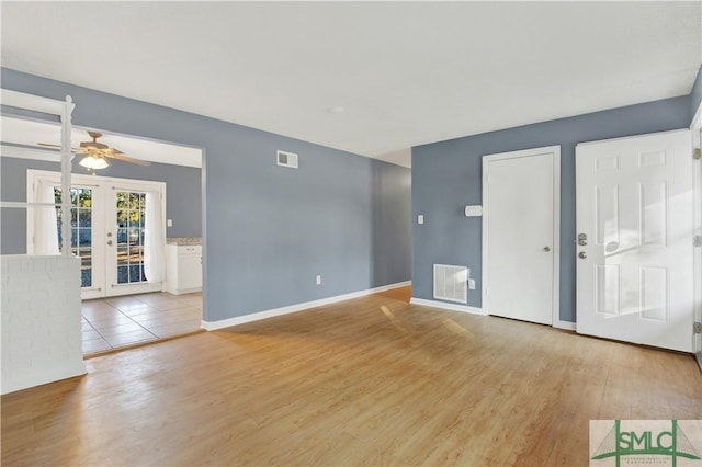 interior space with ceiling fan, french doors, and light hardwood / wood-style flooring