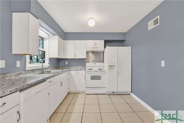 kitchen featuring sink, white appliances, white cabinetry, light tile patterned flooring, and light stone countertops