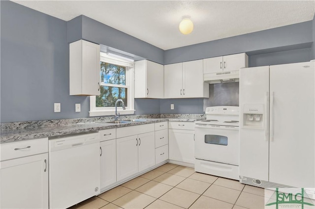 kitchen featuring sink, light tile patterned floors, white appliances, light stone countertops, and white cabinets