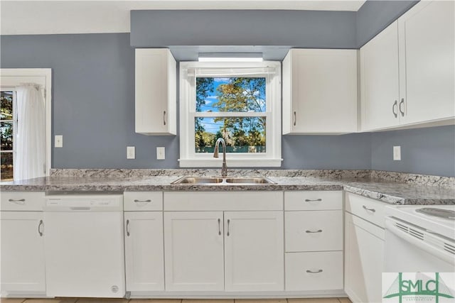 kitchen with dishwasher, sink, white cabinets, and a healthy amount of sunlight