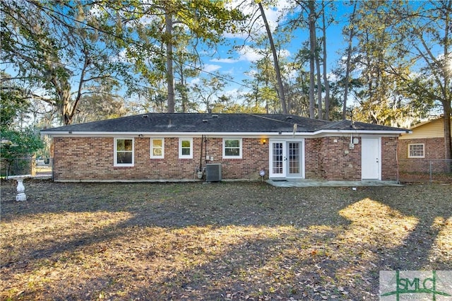 rear view of property featuring central AC, french doors, a yard, and a patio