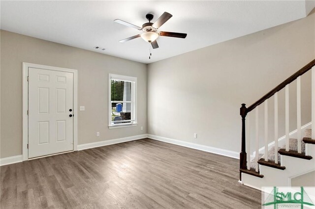 foyer entrance with ceiling fan and hardwood / wood-style floors