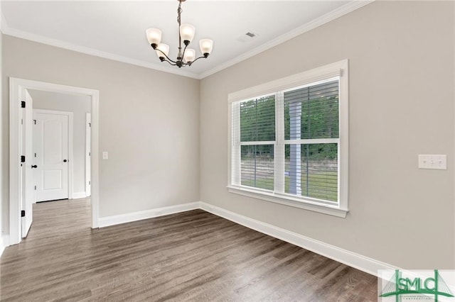 unfurnished room featuring dark hardwood / wood-style floors, a chandelier, and ornamental molding