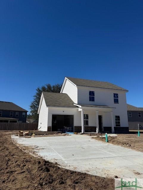 view of front of house with a garage and fence