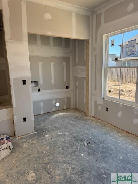 bathroom with crown molding and a wealth of natural light