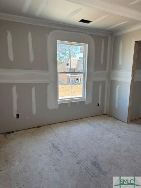 unfurnished room with visible vents