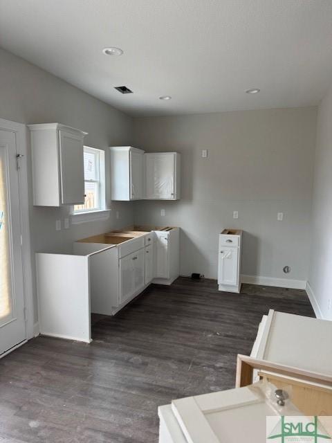 kitchen featuring recessed lighting, dark wood-style floors, visible vents, baseboards, and white cabinetry