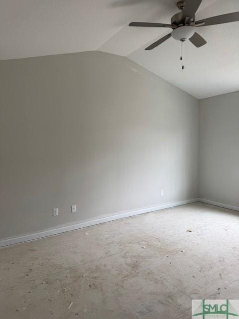 spare room with lofted ceiling, a ceiling fan, and baseboards
