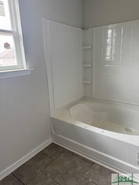 bathroom with baseboards, tile patterned floors, and shower / bathing tub combination