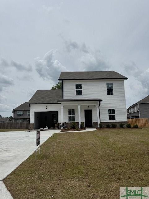 view of front of home featuring a garage, a front lawn, concrete driveway, and fence