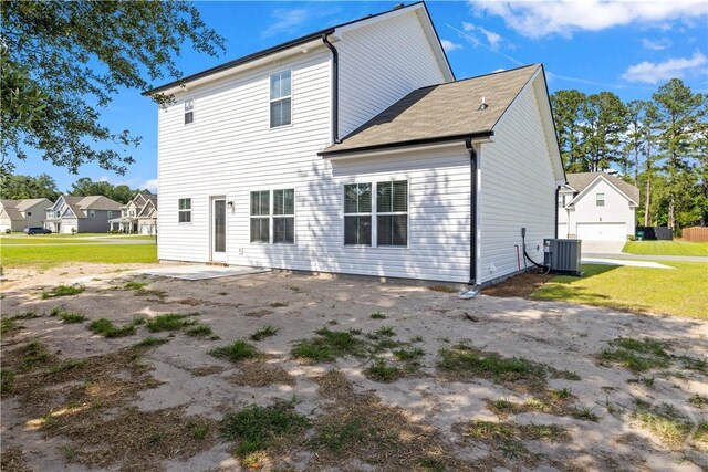 57 Oakmont Dr, Guyton, GA 31312 - back of house featuring central AC unit and a lawn