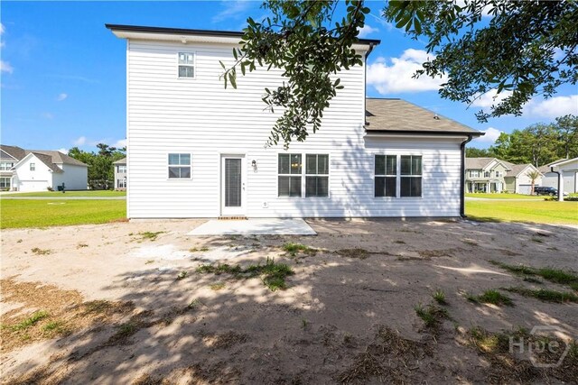 57 Oakmont Dr, Guyton, GA 31312 - rear view of property featuring a patio, a lawn, and a residential view