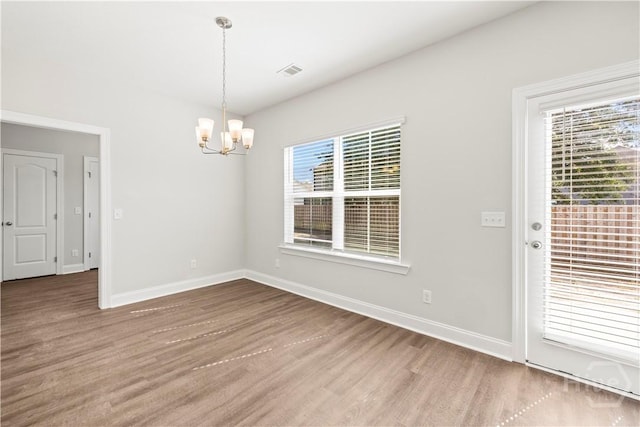 57 Oakmont Dr, Guyton, GA 31312 - unfurnished dining area with a chandelier, wood finished floors, and baseboards