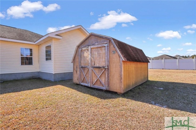 view of outbuilding with a lawn