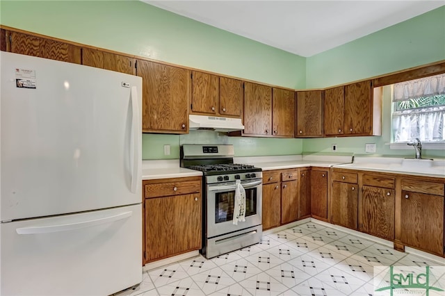 kitchen with stainless steel range with gas cooktop and white fridge