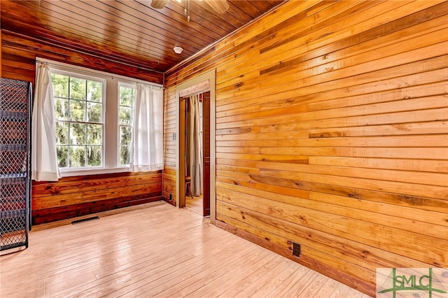 unfurnished sunroom featuring ceiling fan and wood ceiling