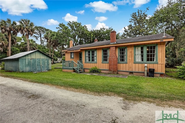 exterior space featuring an outbuilding and a front lawn