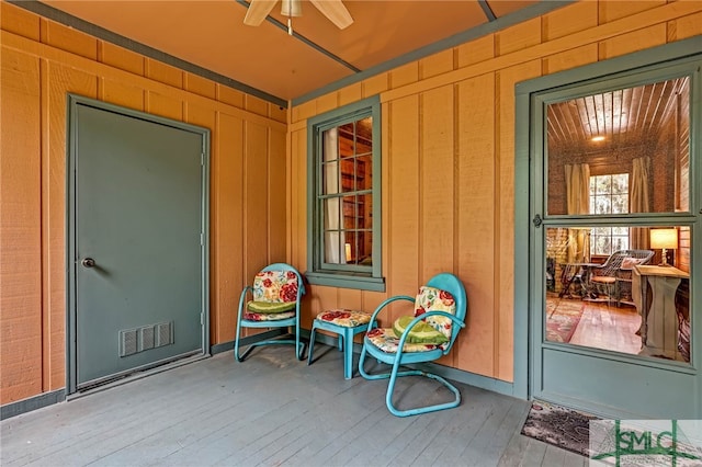 entrance to property featuring ceiling fan and covered porch