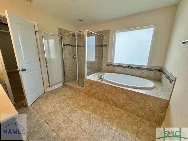 bathroom featuring tile patterned flooring and shower with separate bathtub