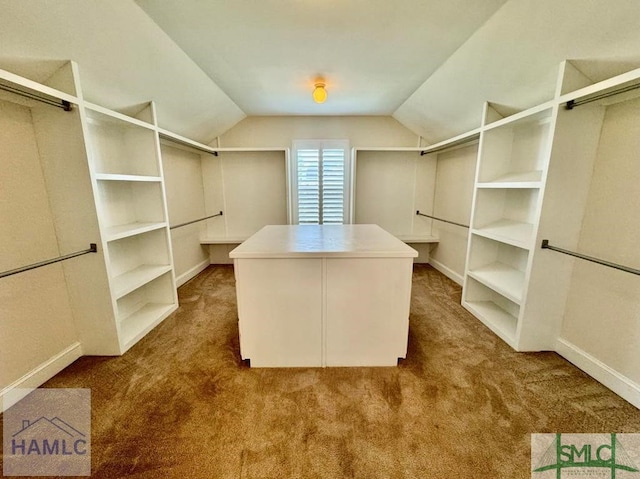 walk in closet featuring vaulted ceiling and carpet