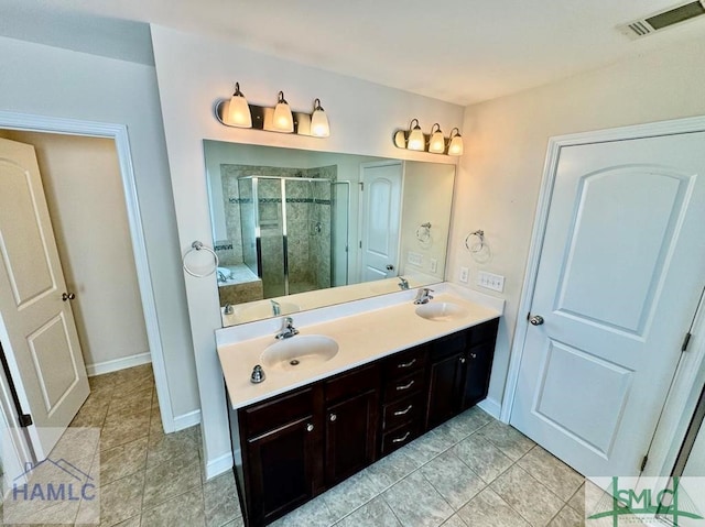 bathroom with a shower with door and vanity