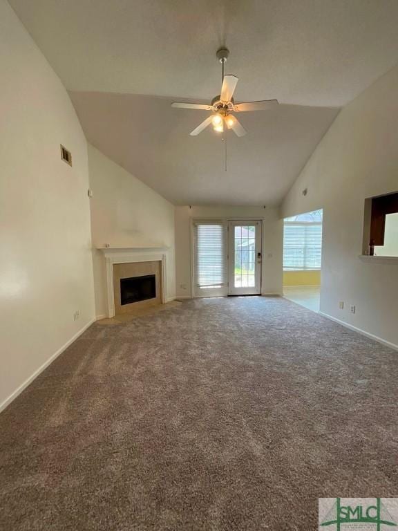 unfurnished living room with ceiling fan, vaulted ceiling, and carpet floors