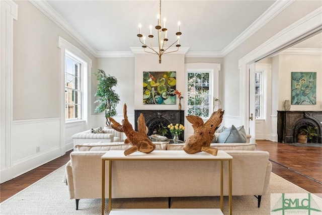 living room featuring crown molding, dark hardwood / wood-style floors, a wealth of natural light, and a notable chandelier