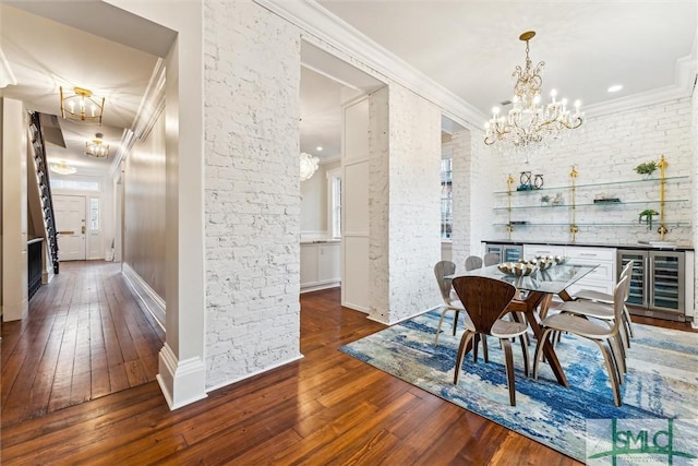 dining space with dark hardwood / wood-style floors, a notable chandelier, beverage cooler, and crown molding