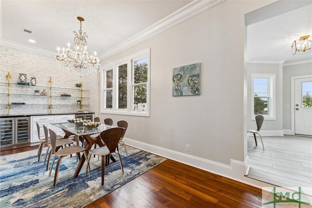 dining space featuring a notable chandelier, crown molding, dark wood-type flooring, and beverage cooler