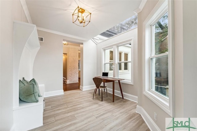 interior space with ornamental molding, light hardwood / wood-style floors, and a chandelier