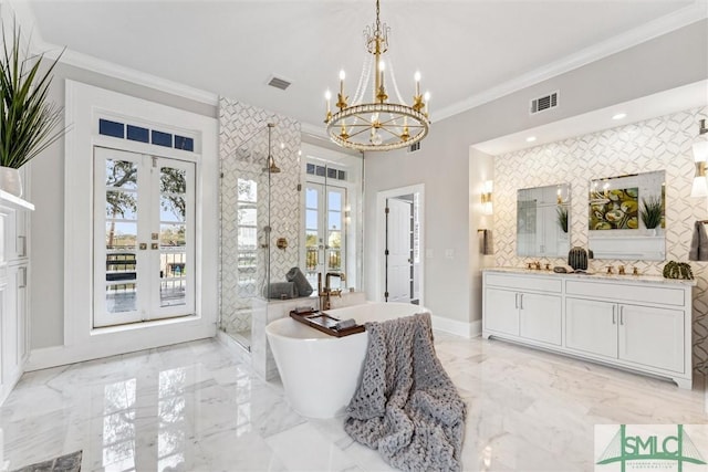 entryway featuring plenty of natural light, an inviting chandelier, and french doors