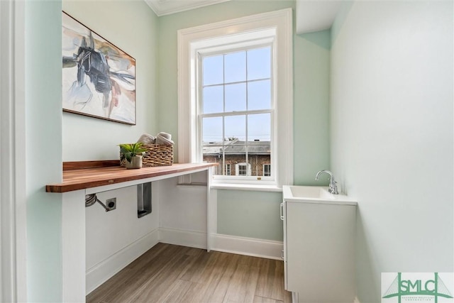 doorway with sink and light hardwood / wood-style flooring