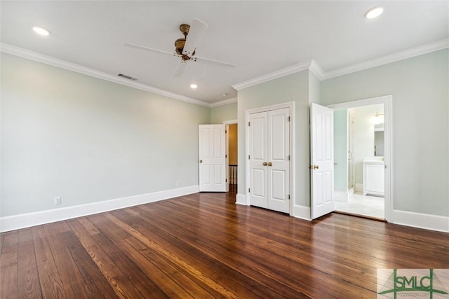 unfurnished bedroom featuring ornamental molding, dark hardwood / wood-style floors, connected bathroom, and ceiling fan