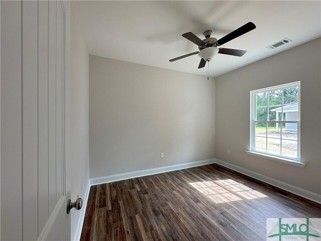 spare room with ceiling fan and dark hardwood / wood-style floors