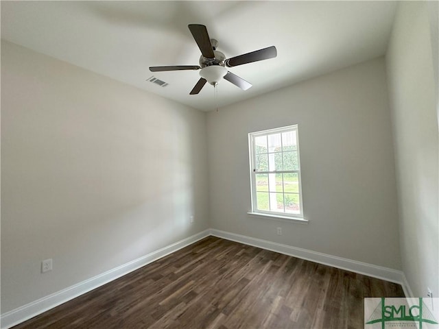 spare room with ceiling fan and dark wood-type flooring