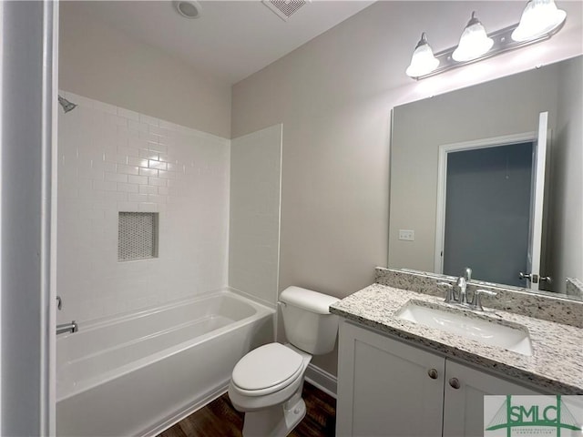 full bathroom with toilet, bathing tub / shower combination, hardwood / wood-style flooring, and vanity