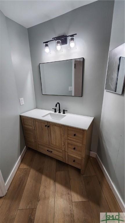 bathroom with hardwood / wood-style flooring and vanity