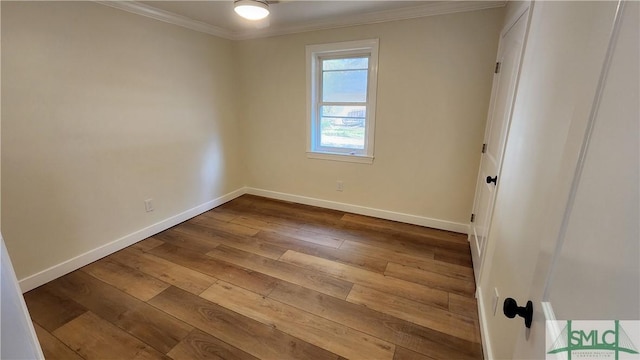 unfurnished room featuring crown molding and wood-type flooring