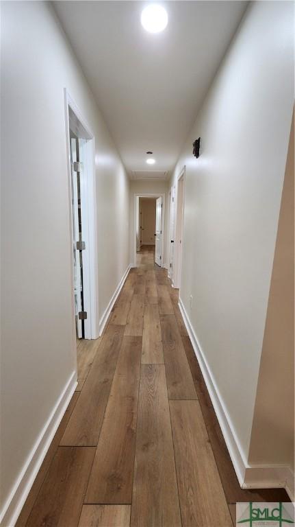 corridor with light hardwood / wood-style flooring