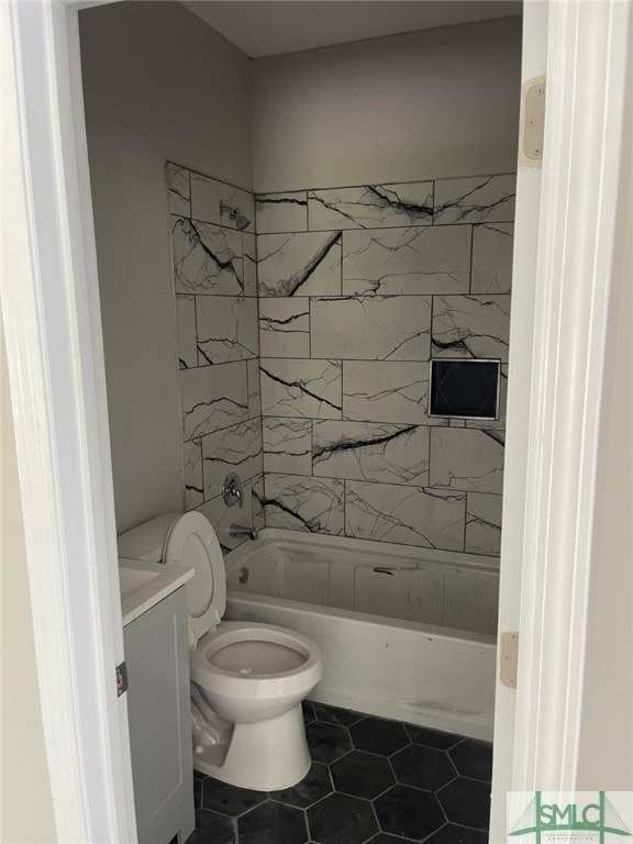 full bathroom with tile patterned floors, toilet, vanity, and tiled shower / bath combo