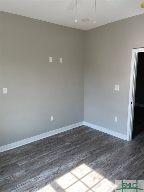 empty room featuring ceiling fan and dark hardwood / wood-style floors