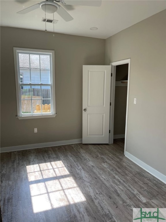 interior space with a closet, ceiling fan, and dark wood-type flooring