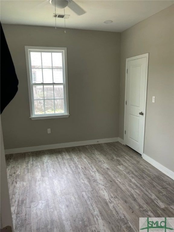 empty room featuring ceiling fan and wood-type flooring